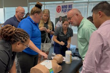 District athletic trainers test out an ECG unit during their training over the summer.