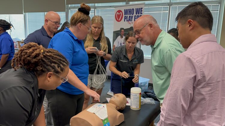 District athletic trainers test out an ECG unit during their training over the summer.