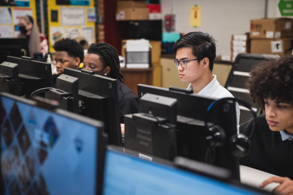 William M. Raines High School students in a computer lab reviewing their work